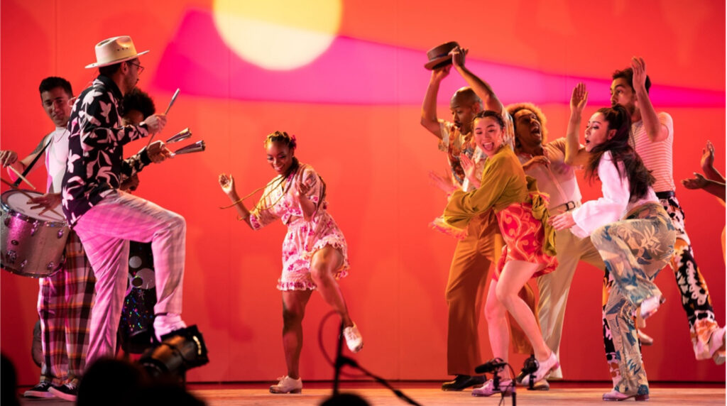 Group of dancers and musicians on stage