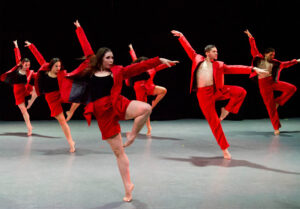 Group of dancers in red on stage